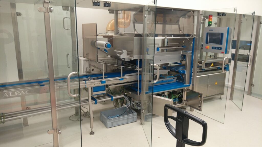 Dismantling Sealpac A7 packaging machine in a sterile pharma facility